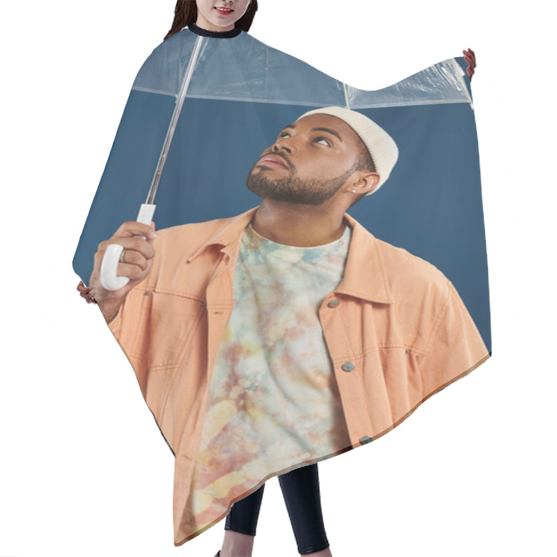 Personality  Stylish Man Holds Clear Umbrella On Blue Backdrop. Hair Cutting Cape