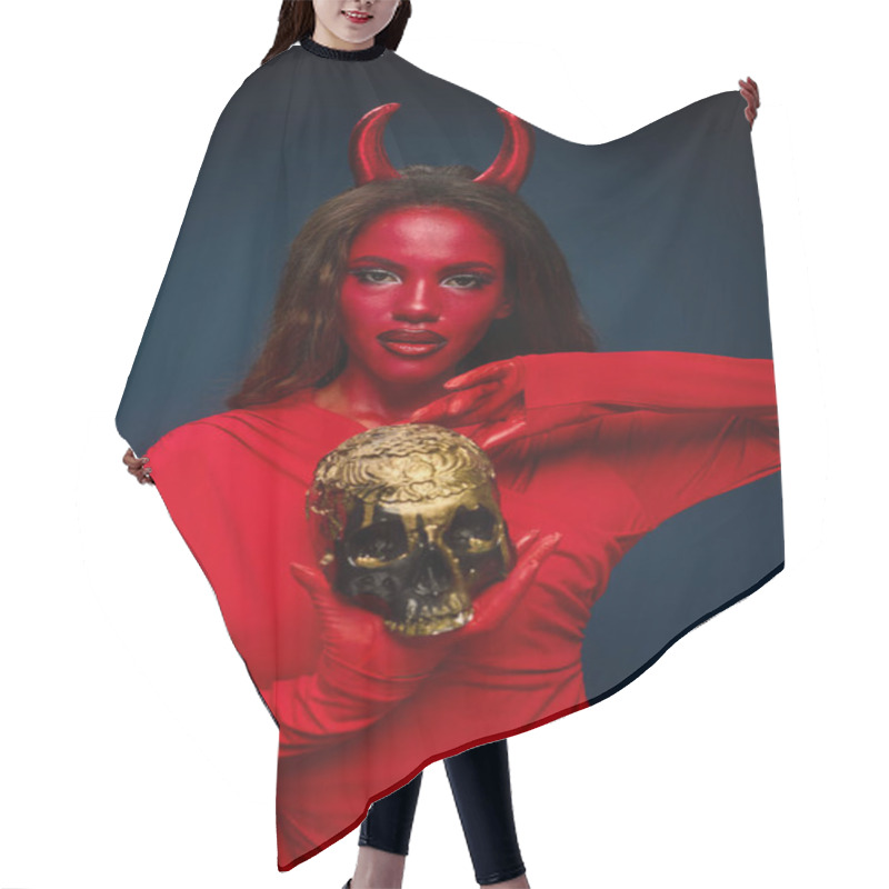 Personality  The Captivating Woman In A Red Devil Costume Poses Confidently, Clutching A Golden Skull. Hair Cutting Cape