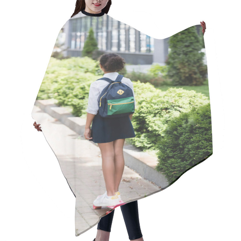 Personality  Back View Of African American Schoolgirl With Backpack Riding Penny Board Outdoors Hair Cutting Cape