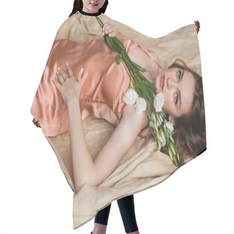 Personality  Attractive Young Woman In Pink Silk Slip Dress Lying On Linen Fabric And Holding Delicate White Flowers On Mottled Beige Background, Sensuality, Sophistication, Elegance, Eustoma, Looking At Camera  Hair Cutting Cape