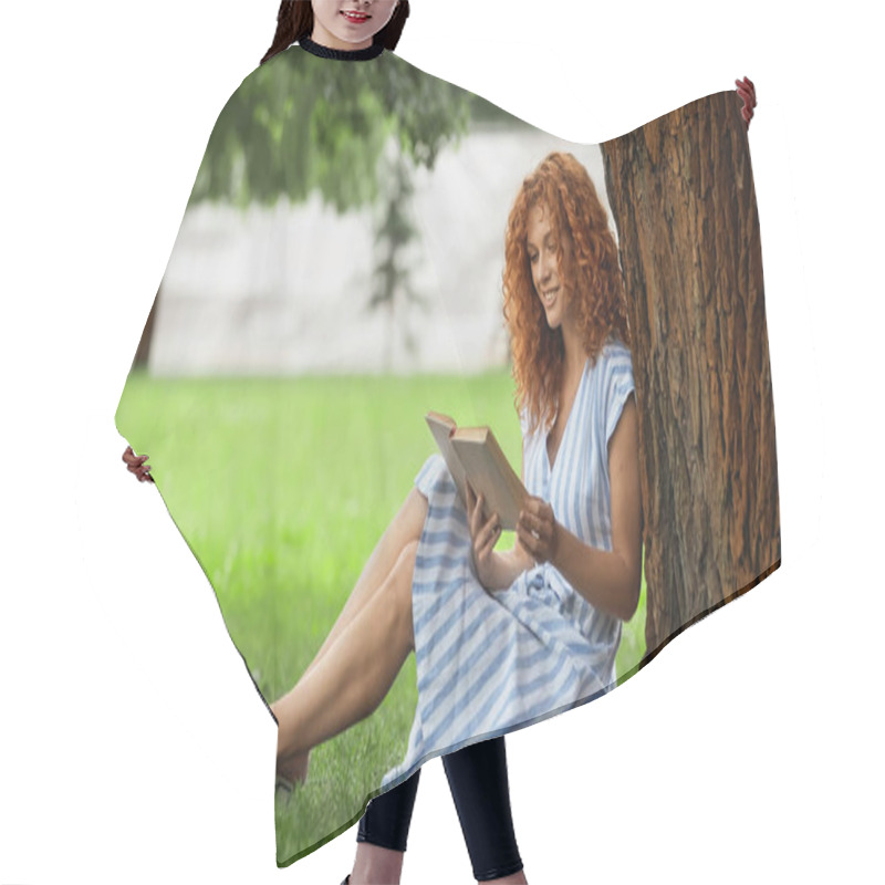 Personality  Full Length Of Cheerful Redhead Woman Reading Book While Sitting Under Tree Trunk  Hair Cutting Cape