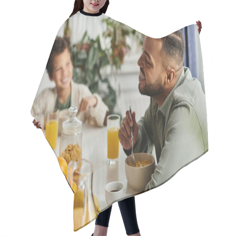 Personality  Men At Table Eating Food Next To His Son. Hair Cutting Cape