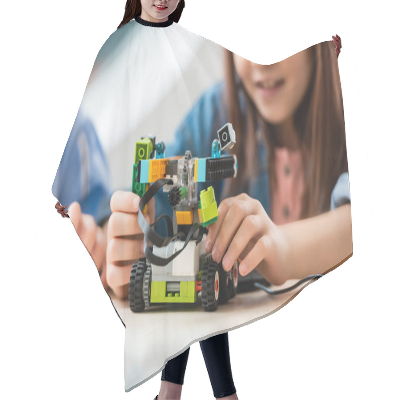 Personality  Selective Focus Of Schoolgirl Programing Robot Near Friend In Stem School  Hair Cutting Cape