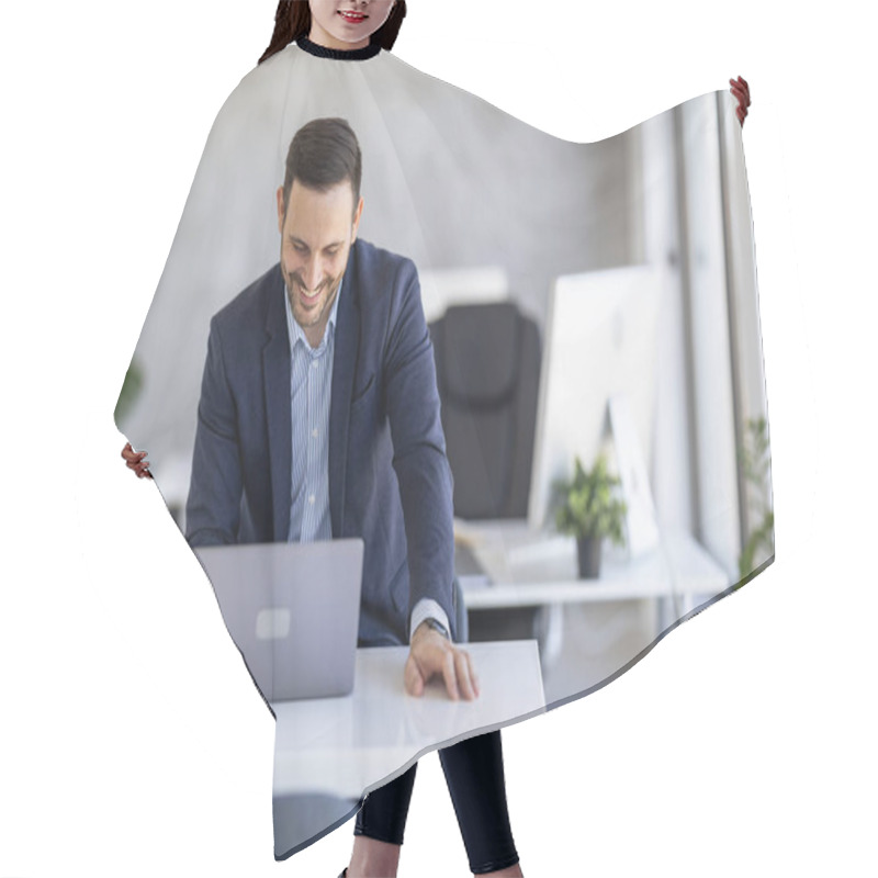 Personality  A Smiling Businessman In A Blue Suit Enjoys Working On A Laptop In A Modern Office Setting. Natural Light And Plants Create A Comfortable And Productive Work Environment. Hair Cutting Cape