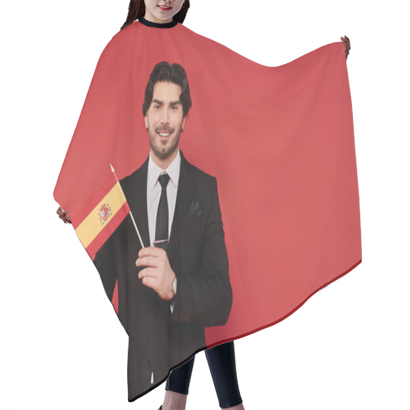 Personality  A Young Handsome Man Stands Proudly, Showcasing A Spanish Flag With Excitement In A Lively Setting. Hair Cutting Cape