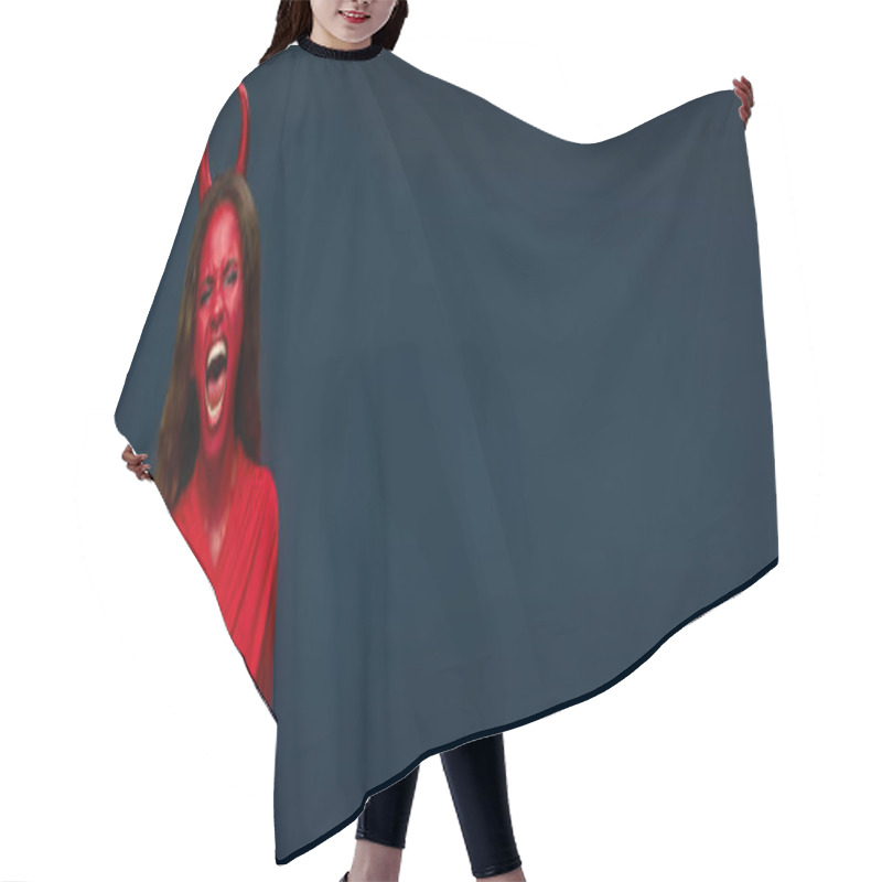 Personality  A Striking Woman In Red With Devil Horns Passionately Celebrates Halloween. Hair Cutting Cape