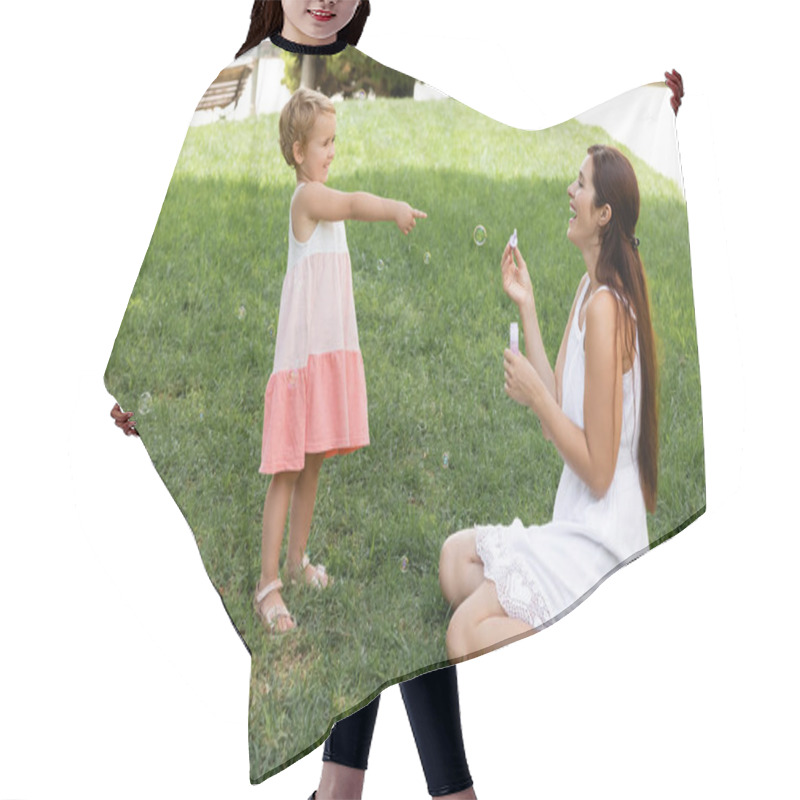 Personality  Smiling Toddler Girl Pointing At Mom With Soap Bubbles In Park  Hair Cutting Cape