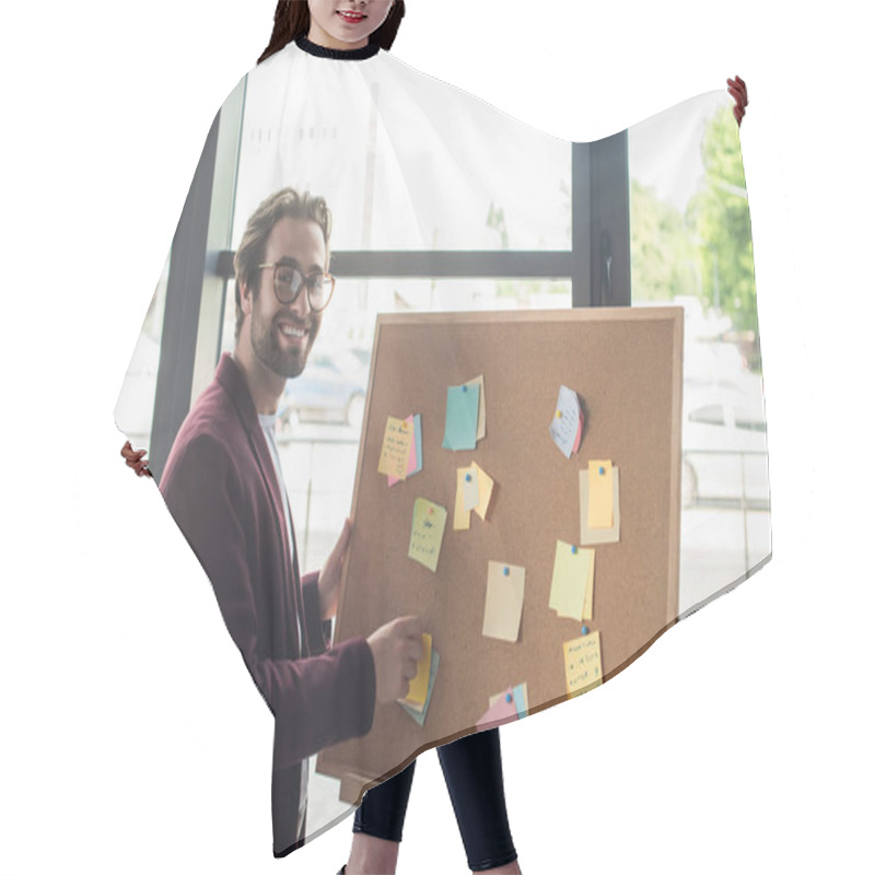 Personality  Positive Businessman In Eyeglasses Looking At Camera Near Board With Sticky Notes  Hair Cutting Cape