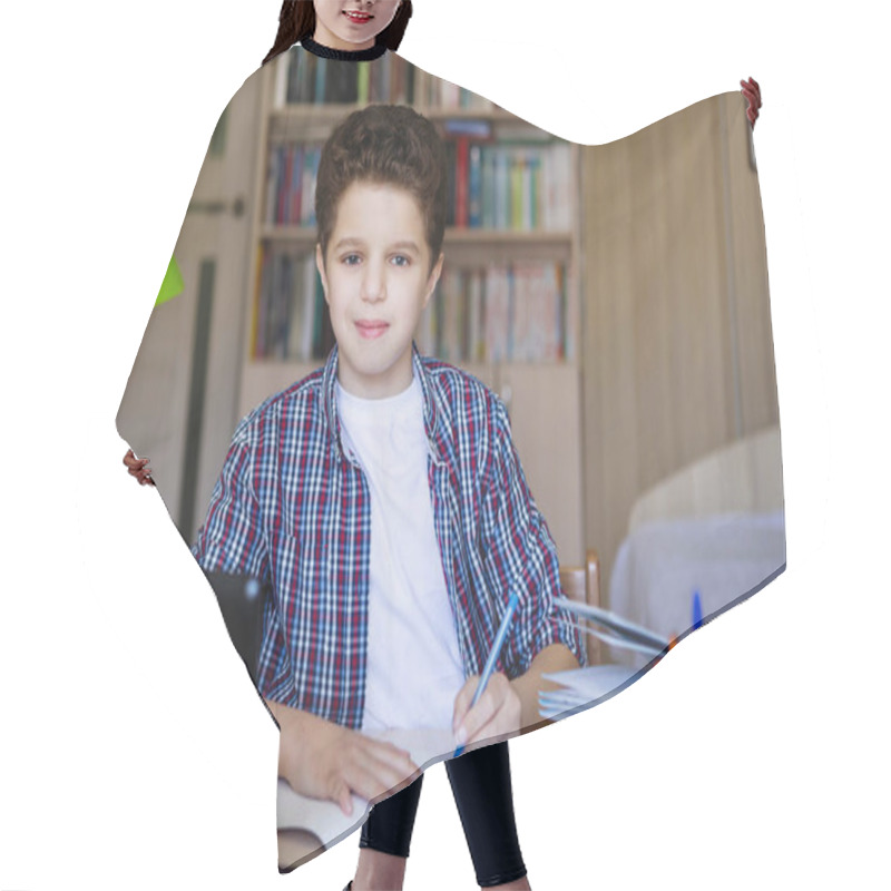 Personality  Teenager Boy In Headphones At A Table With A Laptop Smiles And Looks At The Camera. Coronavirus Quarantined Home Schooling. Selective Focus. Blur Background. Hair Cutting Cape