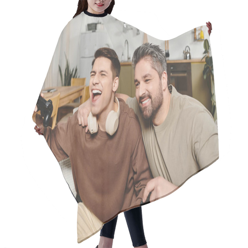 Personality  Two Brothers Share Laughter And Excitement While Playing Video Games In A Comfy Home Setting. Hair Cutting Cape