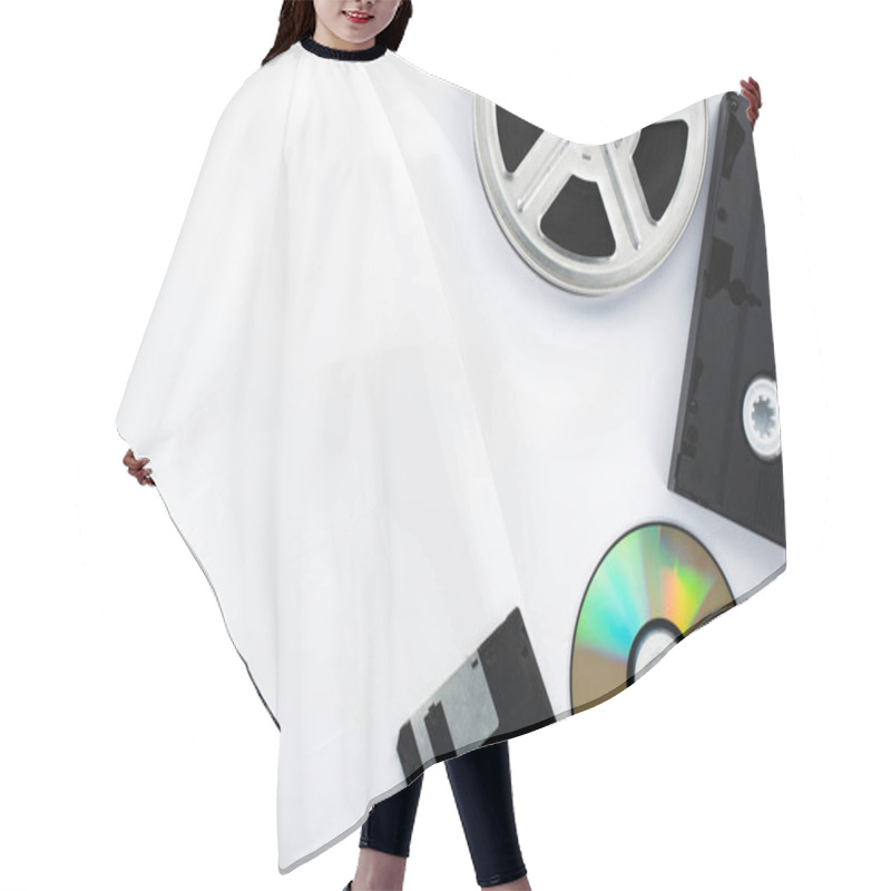 Personality  Top View Of CD Discs, Black VHS Cassette, Diskette And Film Reel On White Background Hair Cutting Cape