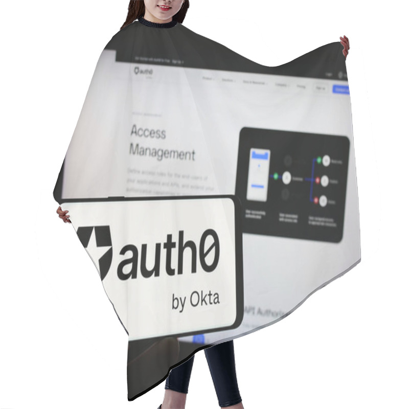 Personality  Stuttgart, Germany - 08-20-2023: Person Holding Cellphone With Logo Of US Identity Platform Company Auth0 By Okta On Screen In Front Of Business Webpage. Focus On Phone Display. Hair Cutting Cape