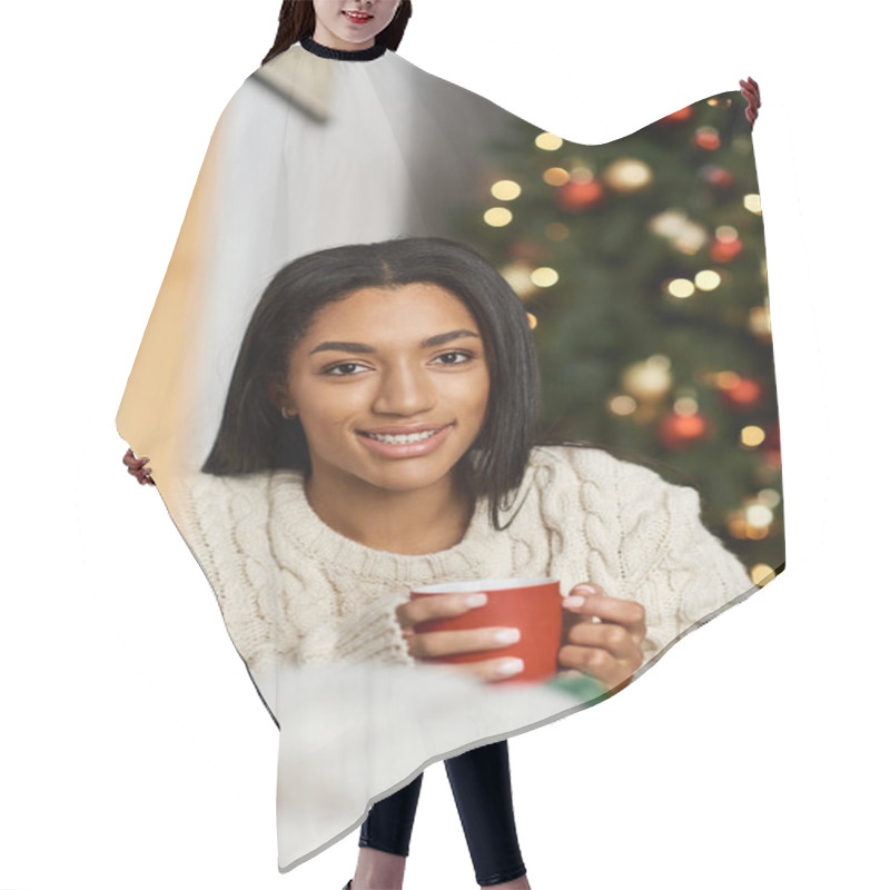 Personality  A Joyful Woman Relaxes, Sipping Warm Beverage In Front Of A Beautifully Decorated Tree. Hair Cutting Cape