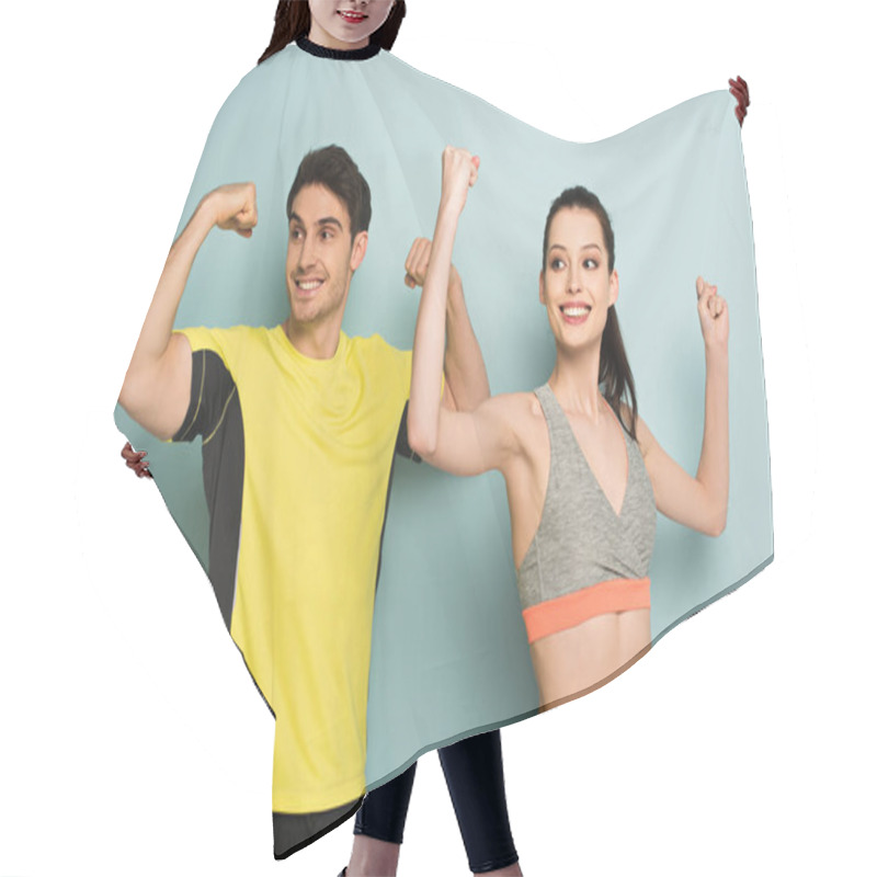 Personality  Happy Athletic Couple Standing In Sportswear Showing Muscles On Blue Hair Cutting Cape