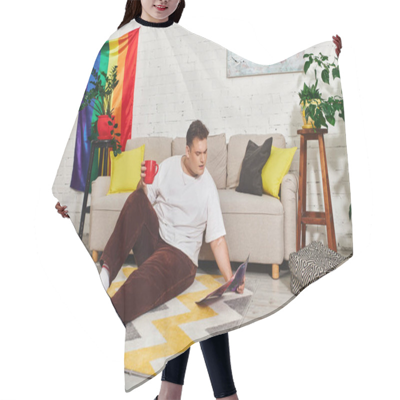 Personality  A Queer Person Relaxes On A Rug While Sipping Coffee And Reading A Magazine In A Vibrant Space. Hair Cutting Cape