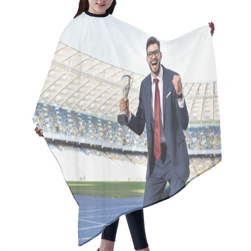 Personality  Happy Young Businessman In Suit Standing On Knees On Running Track With Trophy At Stadium Hair Cutting Cape