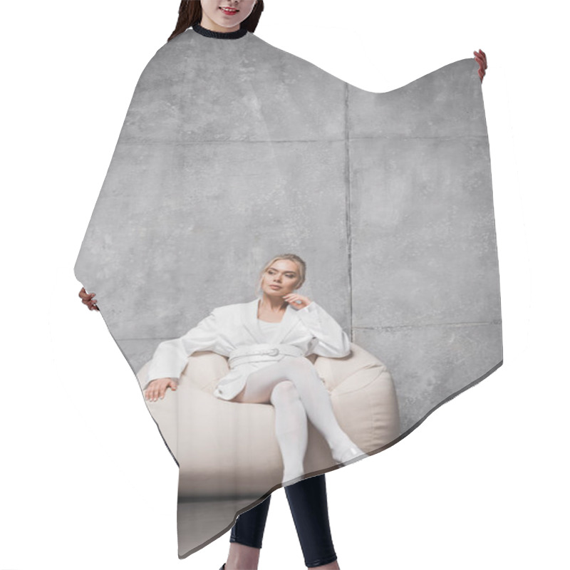 Personality  Pensive Blonde Woman Sitting On Soft Bean Bag Chair On Grey  Hair Cutting Cape