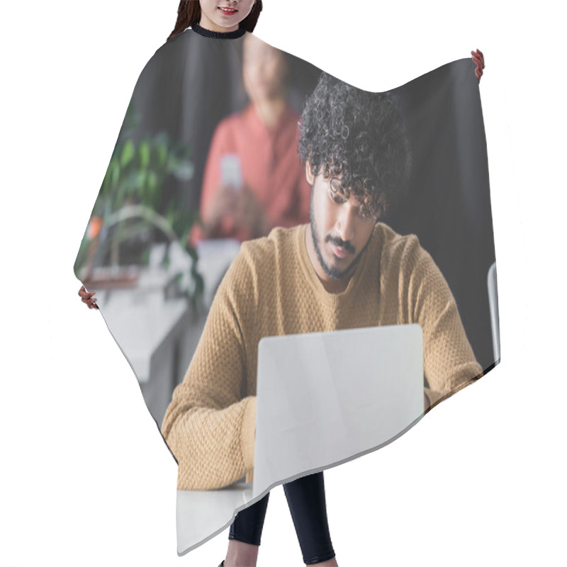 Personality  Curly Indian Advertising Manager Working On Laptop Near Blurred African American Woman Hair Cutting Cape