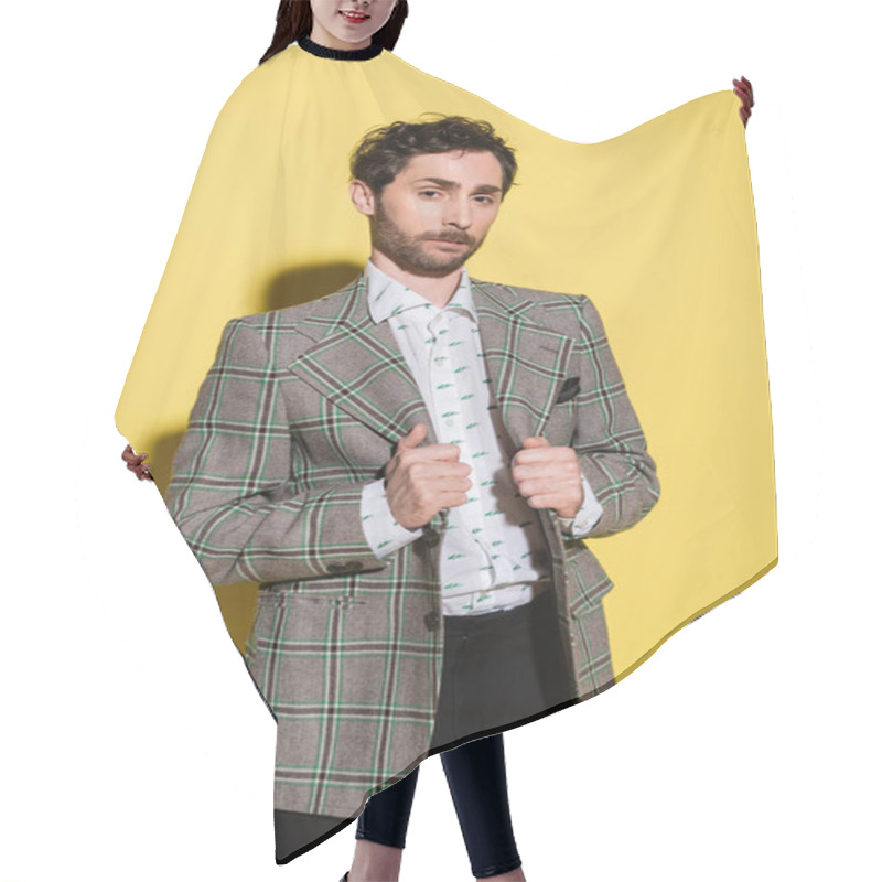 Personality  Bearded Model Adjusting Jacket And Looking At Camera On Yellow Background  Hair Cutting Cape