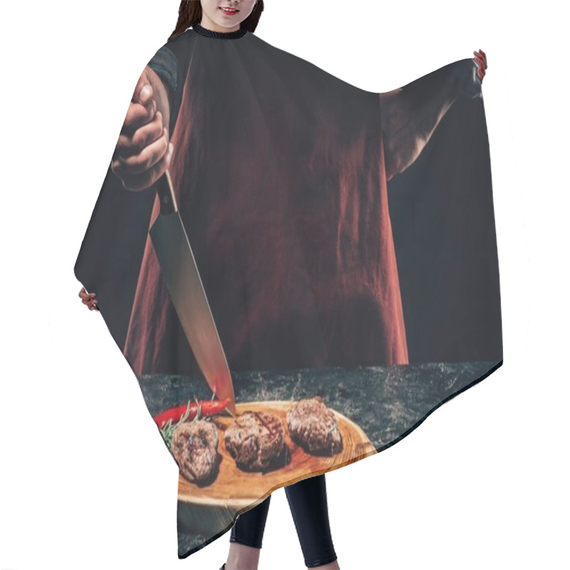 Personality  Cropped Shot Of Chef In Apron Standing With Knife And Delicious Grilled Steaks With Rosemary And Chili Pepper On Wooden Board Hair Cutting Cape