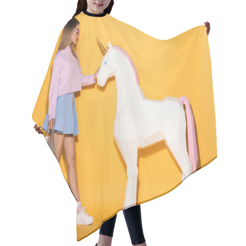 Personality  Side View Of Asian Female Model In Sunglasses Holding Handbag And Touching Decorative Unicorn On Yellow Background  Hair Cutting Cape