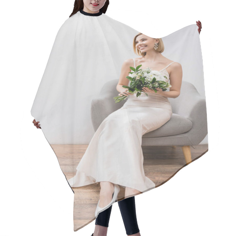 Personality  Wedding Photography, Special Occasion, Beautiful, Blonde Bride In Wedding Dress Sitting In Armchair And Holding Bouquet On Grey Background, White Flowers, Bridal Accessories, Happiness  Hair Cutting Cape