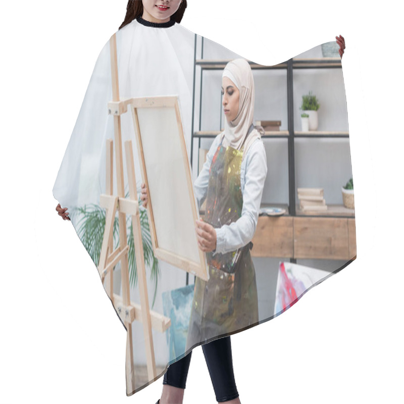 Personality  Muslim Woman In Hijab And Apron Holding Canvas Near Easel At Home Hair Cutting Cape