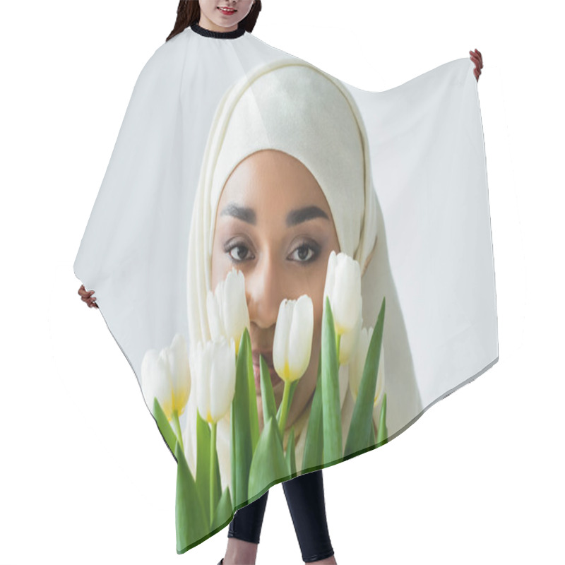 Personality  Muslim Woman In Hijab Looking At Camera Through Tulips Isolated On Grey Hair Cutting Cape