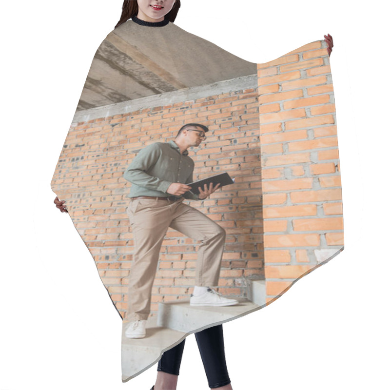 Personality  Full Length Of Realtor With Folder Standing On Stairs In House With Unfinished Interior Hair Cutting Cape