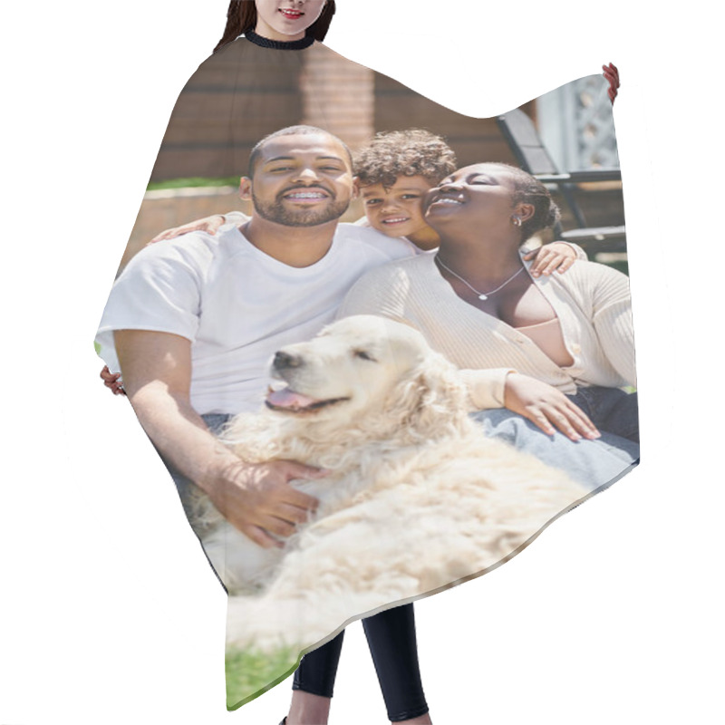 Personality  Family Portrait Of Cheerful African American Parents And Son Smiling And Sitting On Lawn Near Dog Hair Cutting Cape