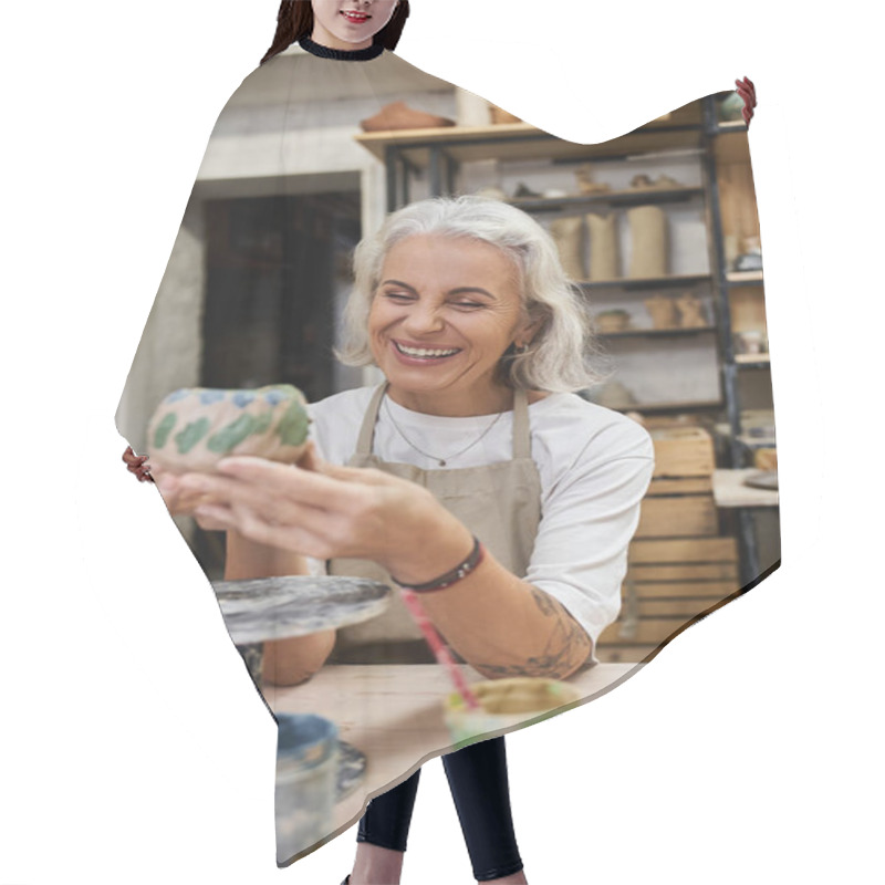 Personality  A Mature Woman Smiles Brightly While Crafting A Unique Pottery Piece In Her Artistic Studio Setting. Hair Cutting Cape