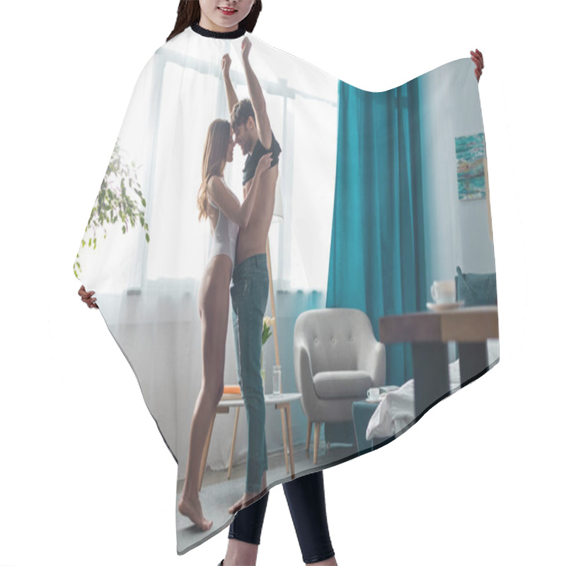 Personality  Side View Of Sexy Smiling Woman Undressing Handsome Boyfriend At Home  Hair Cutting Cape