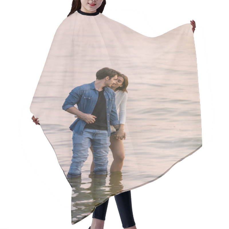 Personality  Young Couple Holding Hands While Standing In Sea Water At Sunset  Hair Cutting Cape