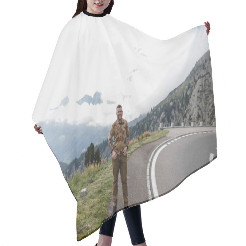 Personality  Handsome Young Man Standing On Asphalt Road In Mountains And Smiling At Camera, Alps  Hair Cutting Cape