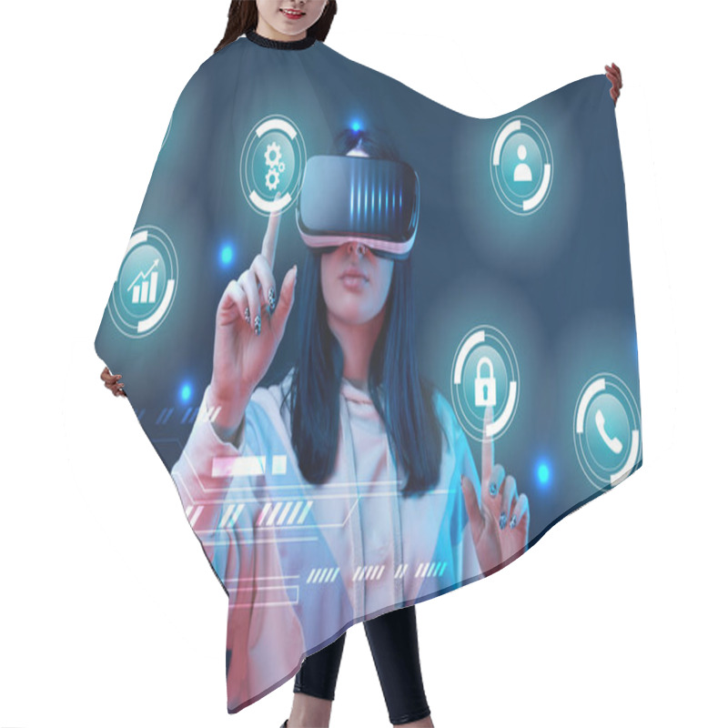 Personality  Young Woman In Virtual Reality Headset Pointing With Fingers At Glowing Cyber Icons On Dark Background Hair Cutting Cape