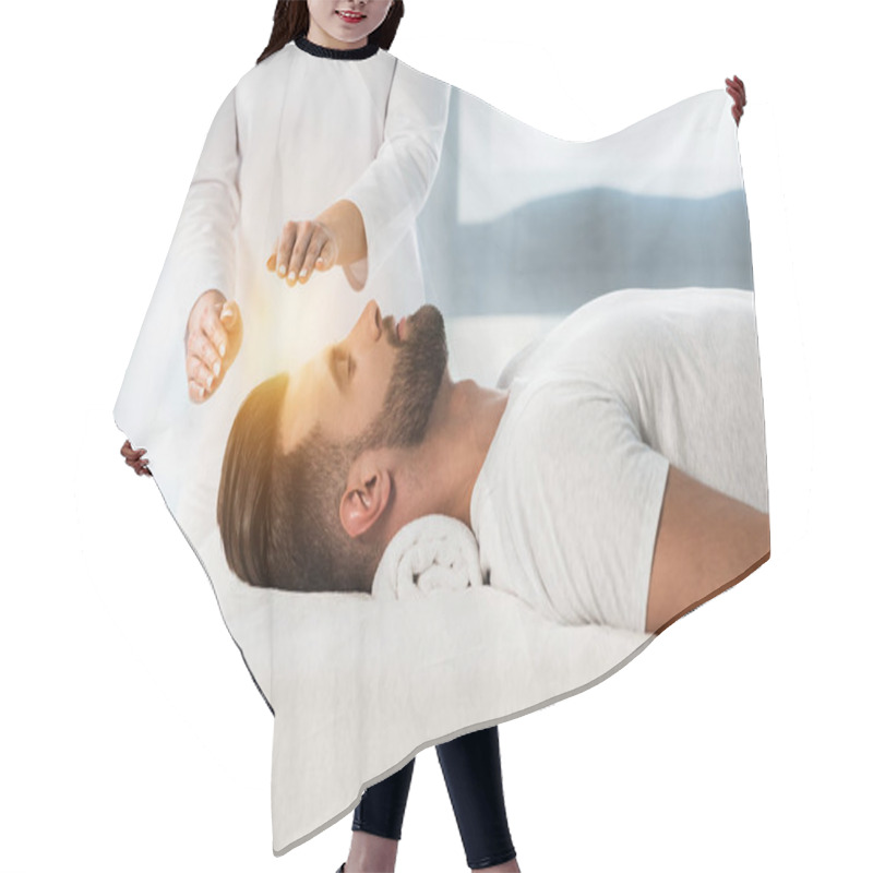 Personality  Cropped View Of Healer Putting Hands Above Head Of Young Man With Closed Eyes  Hair Cutting Cape