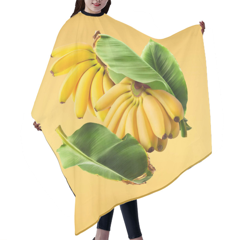 Personality  Fresh Ripe Baby Bananas With Leaves Falling In The Air Isolated On Yellow Background. Food Levitation Concept. High Resolution Image Hair Cutting Cape