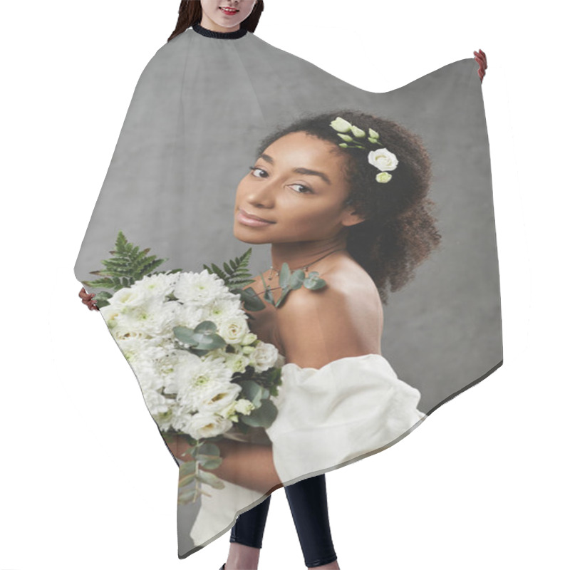 Personality  African American Bride In White Dress With Flowers In Her Hair Holds Bouquet Against Grey Background. Hair Cutting Cape