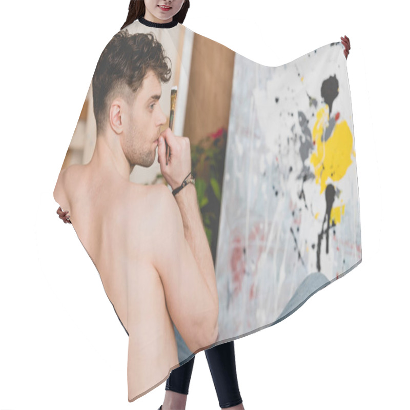 Personality  Selective Focus Of Handsome Half-naked Artist Sitting On Floor In Front Of Canvas With Picture Hair Cutting Cape