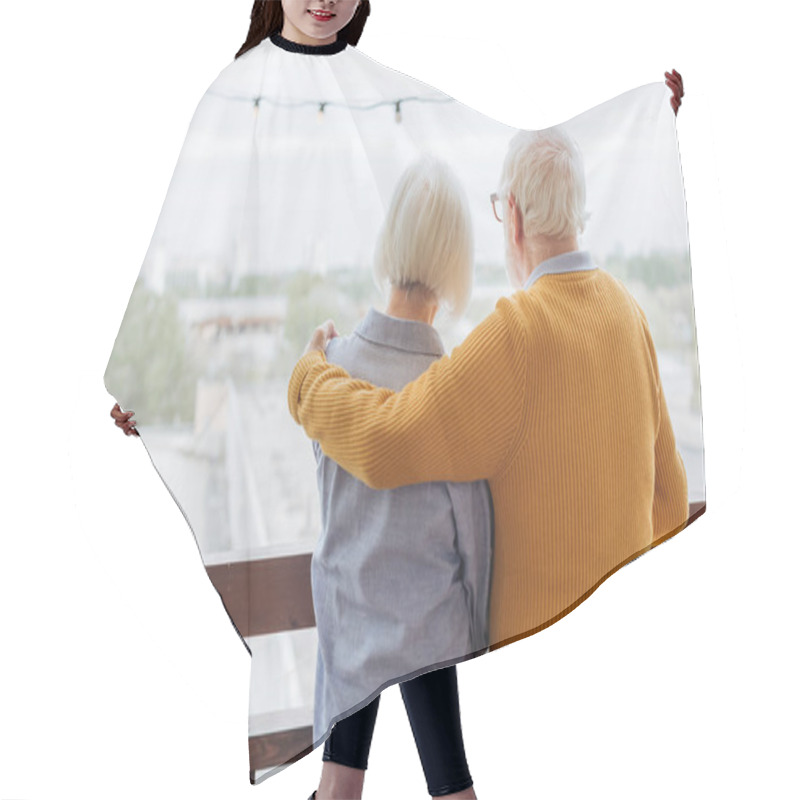 Personality  Back View Of Senior Husband Hugging Wife On Terrace On Blurred Background Hair Cutting Cape