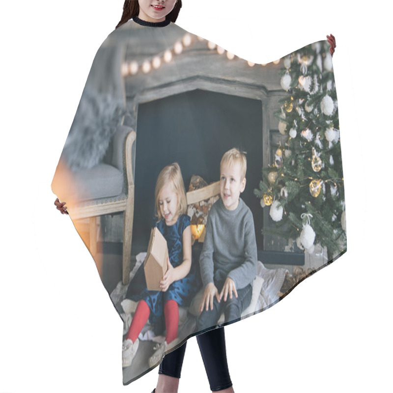 Personality  Children - A Boy And A Girl Are Sitting By The Fireplace, A New Year Tree, Playing With Cardboard Houses, A Cozy Christmas Decor And Children's Emotions Hair Cutting Cape