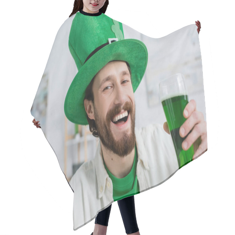 Personality  Cheerful Man In Saint Patrick Hat Holding Green Beer And Looking At Camera At Home  Hair Cutting Cape