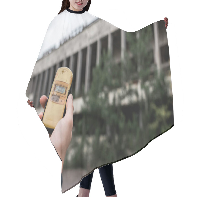 Personality  PRIPYAT, UKRAINE - AUGUST 15, 2019: Cropped View Of Man Holding Radiometer Near Building In Chernobyl  Hair Cutting Cape