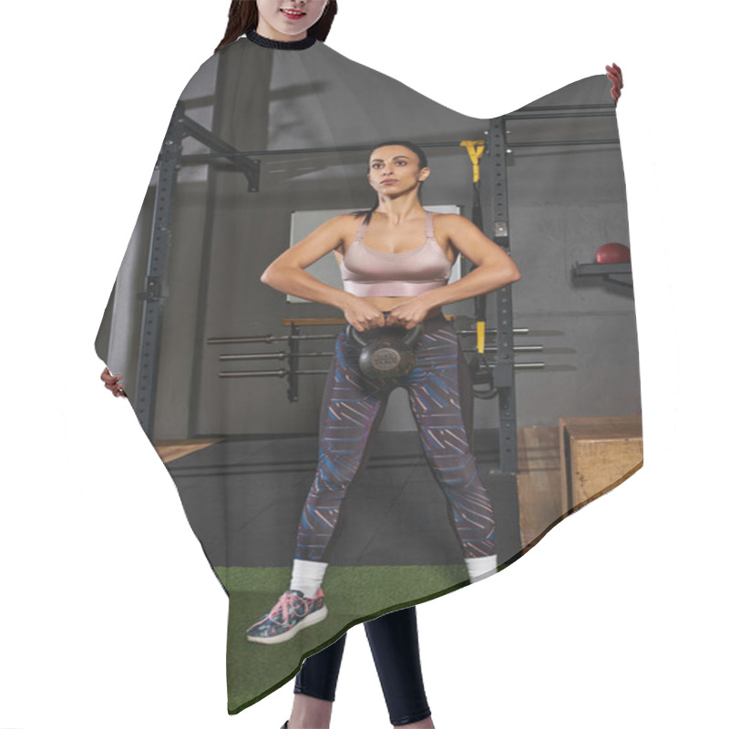 Personality  Dedicated Woman Performs Kettlebell Exercise In A Modern Gym Environment With Equipment. Hair Cutting Cape