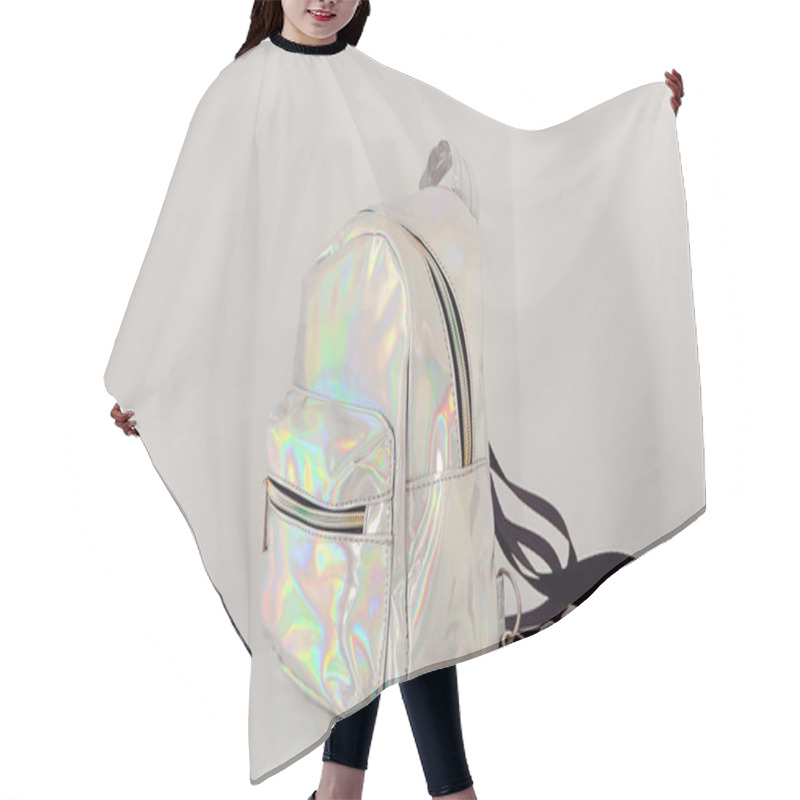 Personality  Stylish Backpack From Iridescent Material On Table Near White Wall Hair Cutting Cape