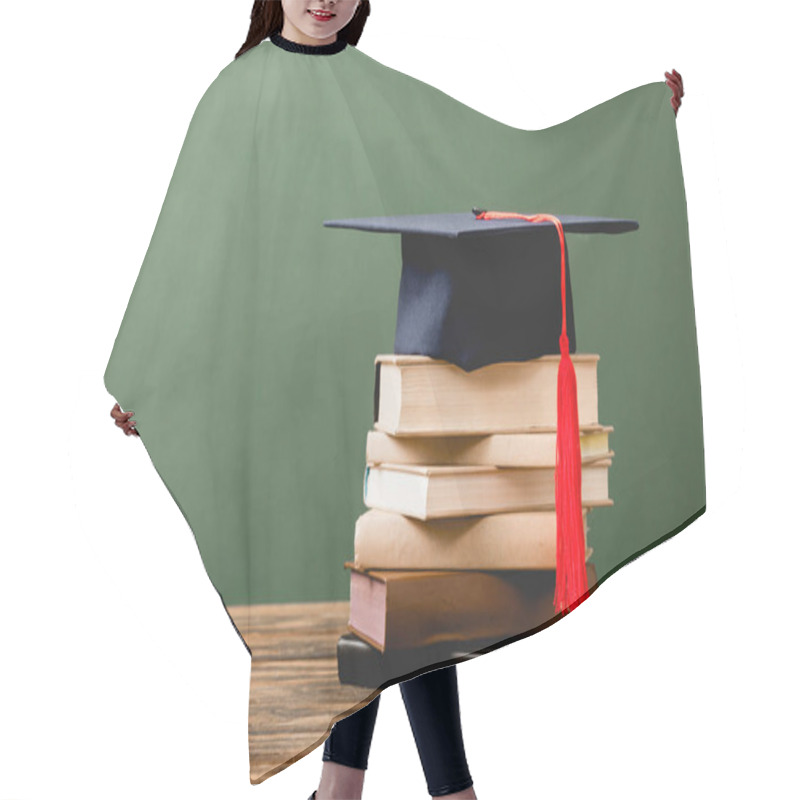 Personality  Books And Academic Cap On Wooden Surface Isolated On Green Hair Cutting Cape