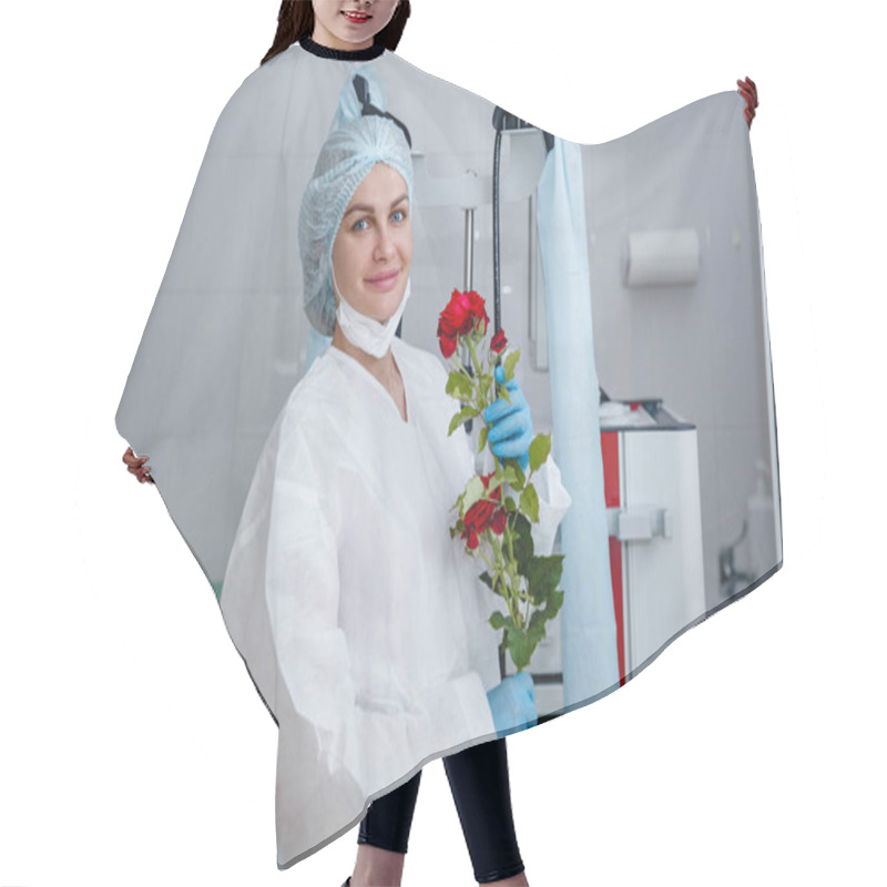 Personality  A Young Female Doctor In A White Protective Suit, Cap And Gloves Holds A Red Rose Presented To Her Hair Cutting Cape