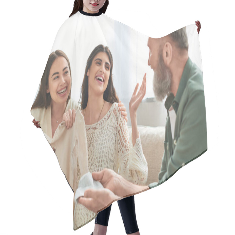 Personality  Father Showing Beanie And Singlet To His Pregnant Daughter And Her Cheerful Partner, Ivf Concept Hair Cutting Cape