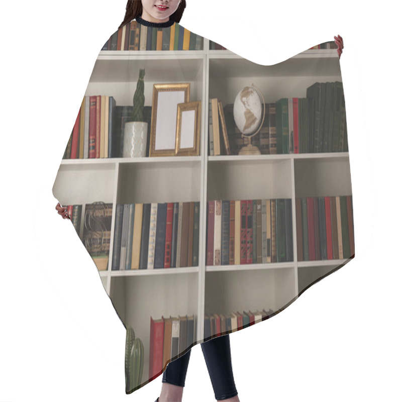 Personality  Collection Of Books And Decor Elements On Shelves. Home Library Hair Cutting Cape