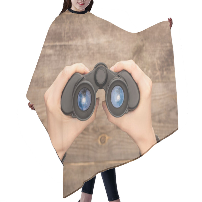 Personality  Selective Focus Of Woman Holding Binoculars On Wooden Table Hair Cutting Cape